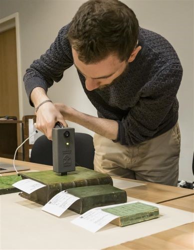 Morgan Facchin using device on the books