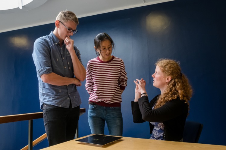 Two students and their supervisor in discussion. copyright broaddaylight