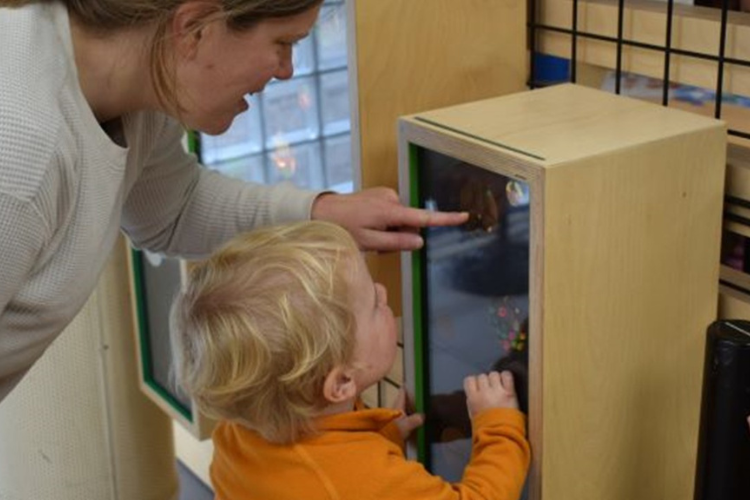 Parent and Child look into a box