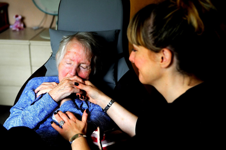 Lady kissing carer hand