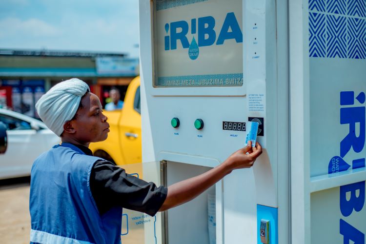 Photograph of a person using the Iriba ATM water machine