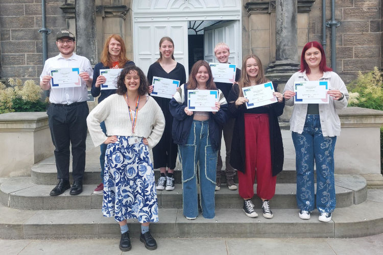 First Chances Fife student group holding their certificates at the entrance of a historic building