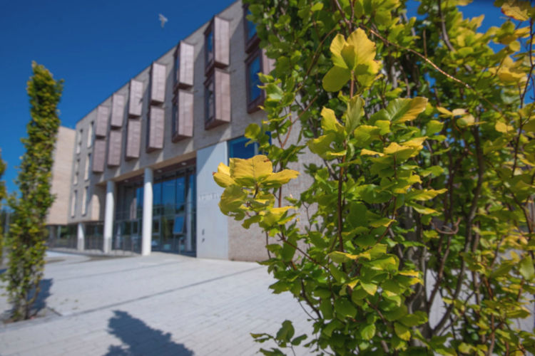 Side view of Powell Hall showing the hall of residence and surrounding shrubs