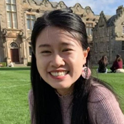 Ruoxi Wang sitting on the lawn at St Salvators Quad