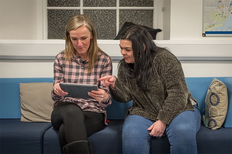 Two women looking at an iPad