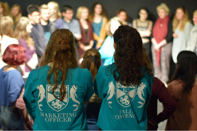 Two people facing group of students
