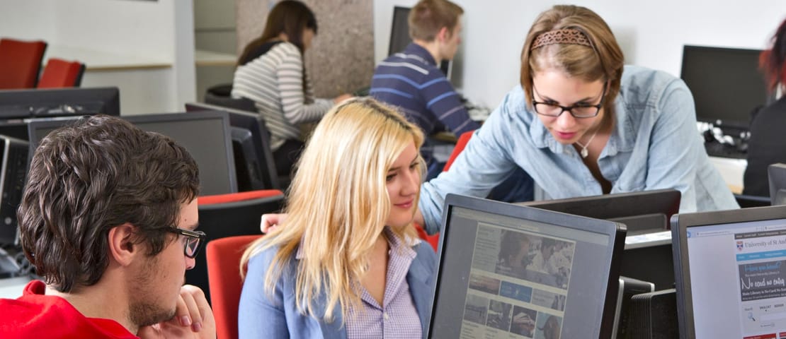 Students gathered around a computer