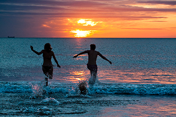 Students running into the sea in the morning