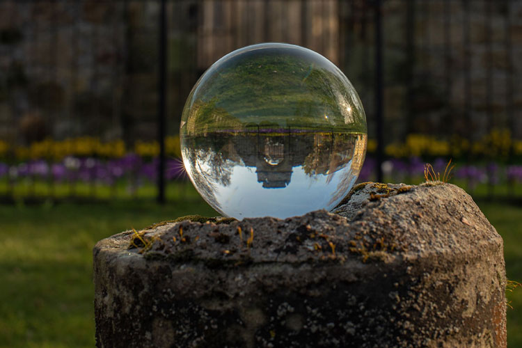 Glass ball reflecting old building in St Andrews