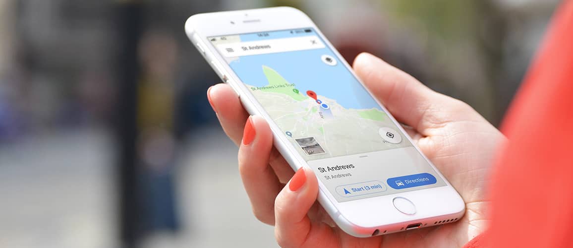 Holding an iPhone with a map of St Andrews